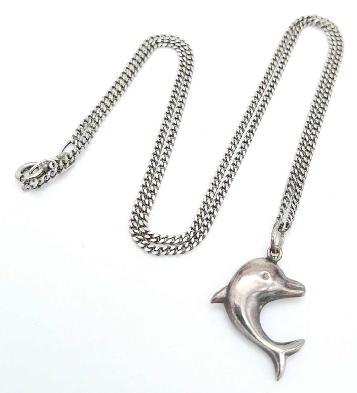 A vintage sterling silver dolphin pendant on silver curb chain. Total weight 4.2G. Total length - Image 2 of 6