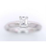 AN 18K WHITE GOLD EMERALD CUT DIAMOND SOLITAIRE RING. 0.34CT. 3.6G. SIZE N.