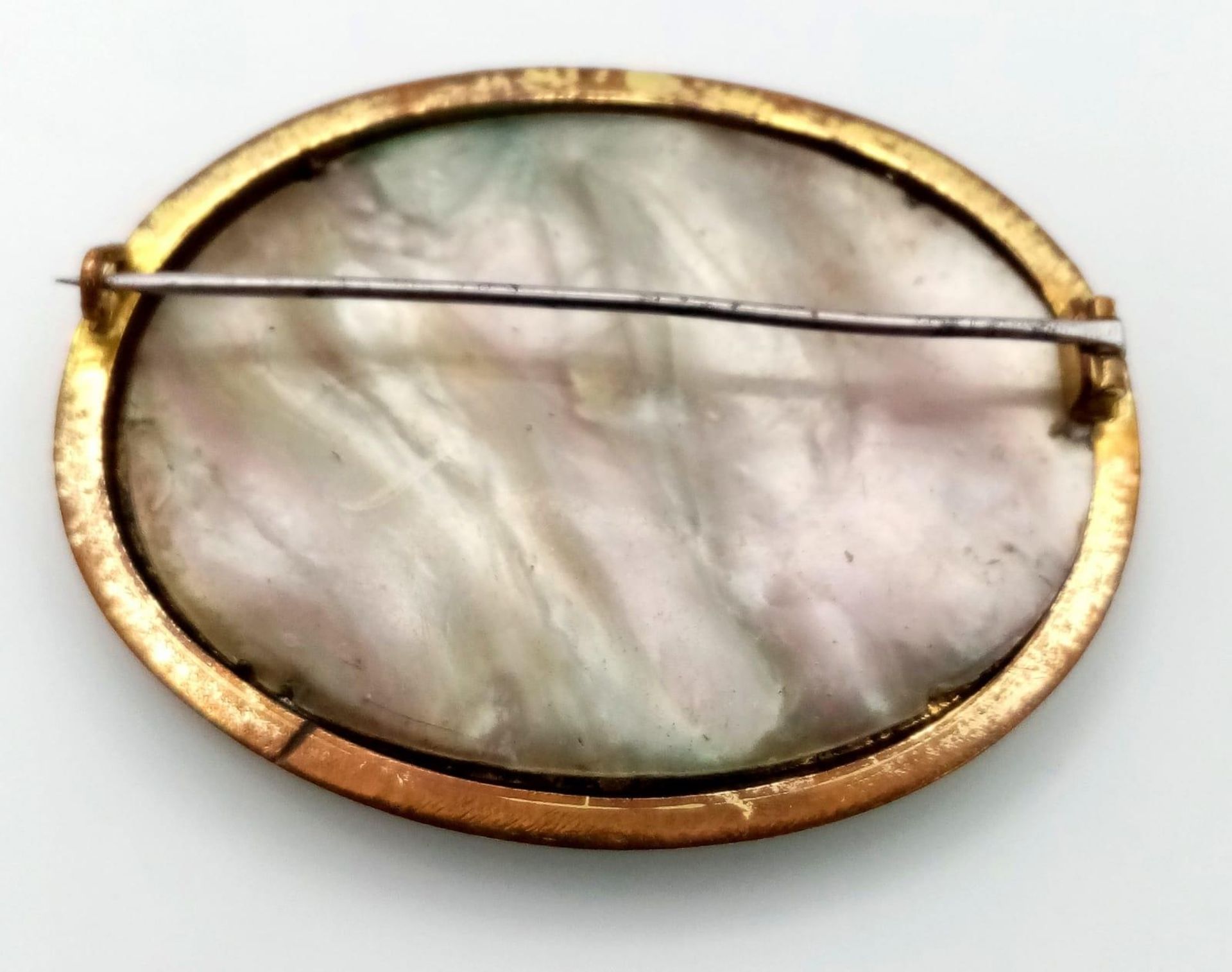 An Antique Bronze, Brass and Mother of Pearl Brooch. Brass and mop foundations with a decorative - Image 2 of 6