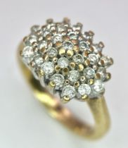 A 9K YELLOW GOLD DIAMOND CLUSTER RING. 0.50CT. 3.8G. SIZE K.