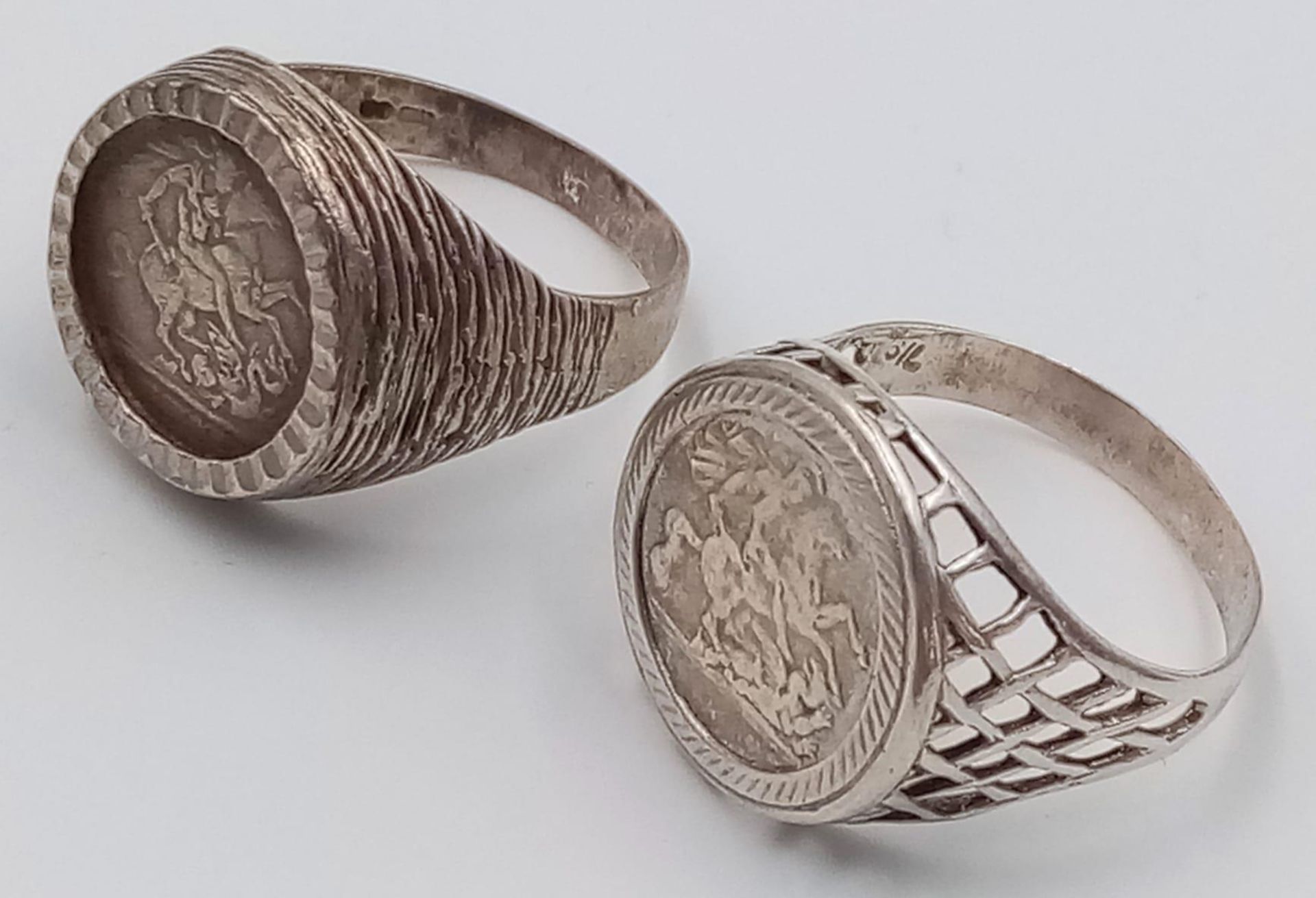 2X vintage sterling silver St George "killing the dragon" rings. Total weight 11.7G. Size U/V and V.