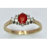 A Vintage 9K Yellow Gold, Red Sapphire and Diamond Ring. Oval sapphire with diamond accents. Size O.