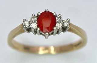 A Vintage 9K Yellow Gold, Red Sapphire and Diamond Ring. Oval sapphire with diamond accents. Size O.