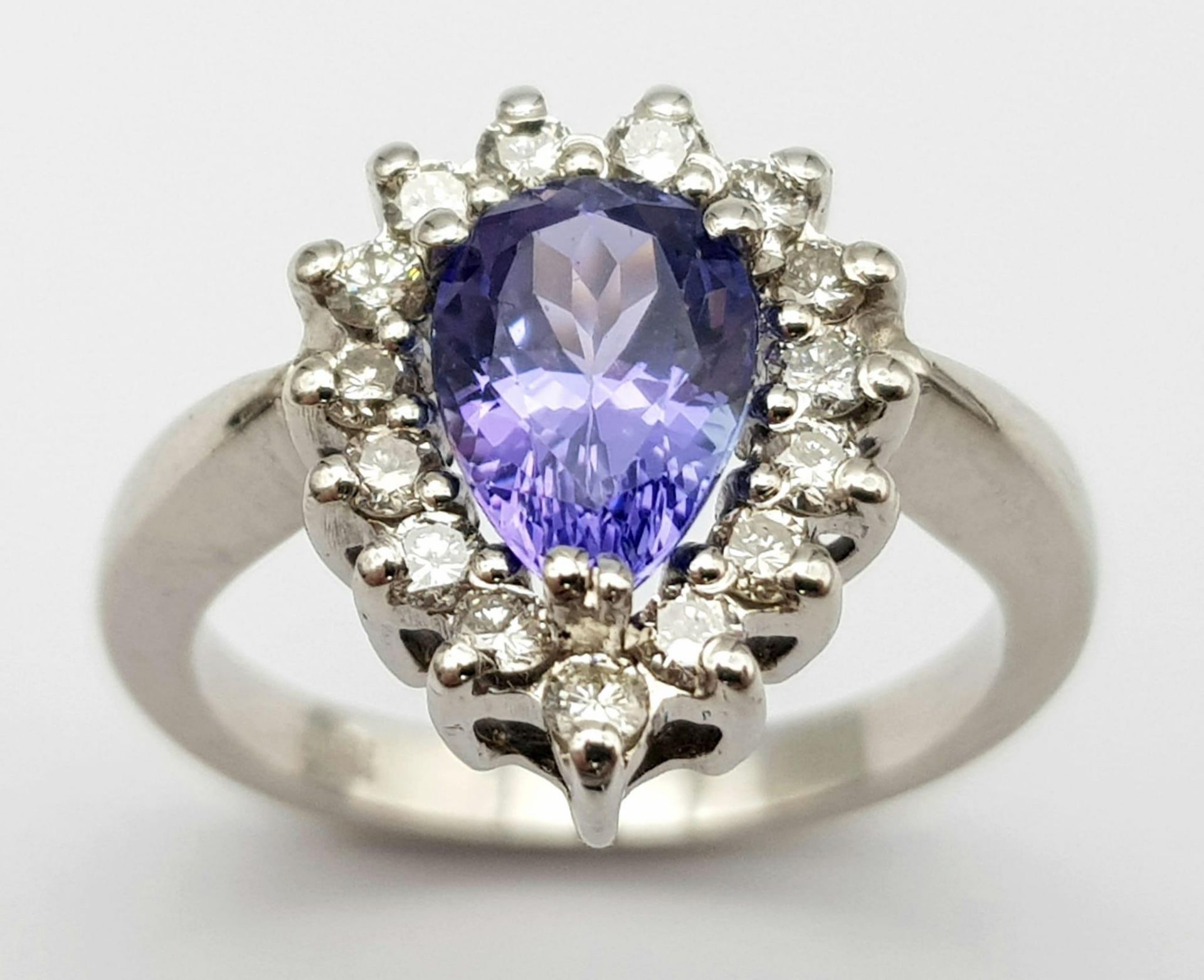 An 18 K white gold ring with a pear cut tanzanite (1.71 carats) surrounded by a halo of diamonds, - Image 2 of 12