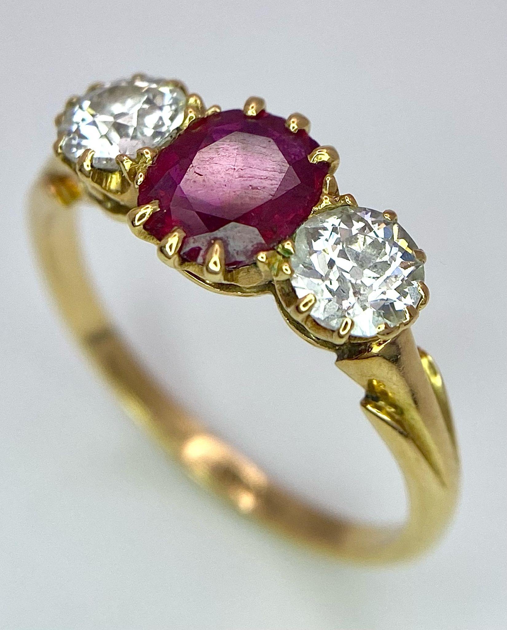 A Mesmerising 18K Yellow Gold, Ruby and Diamond Ring. A deep red oval cut ruby sits central - Image 2 of 9