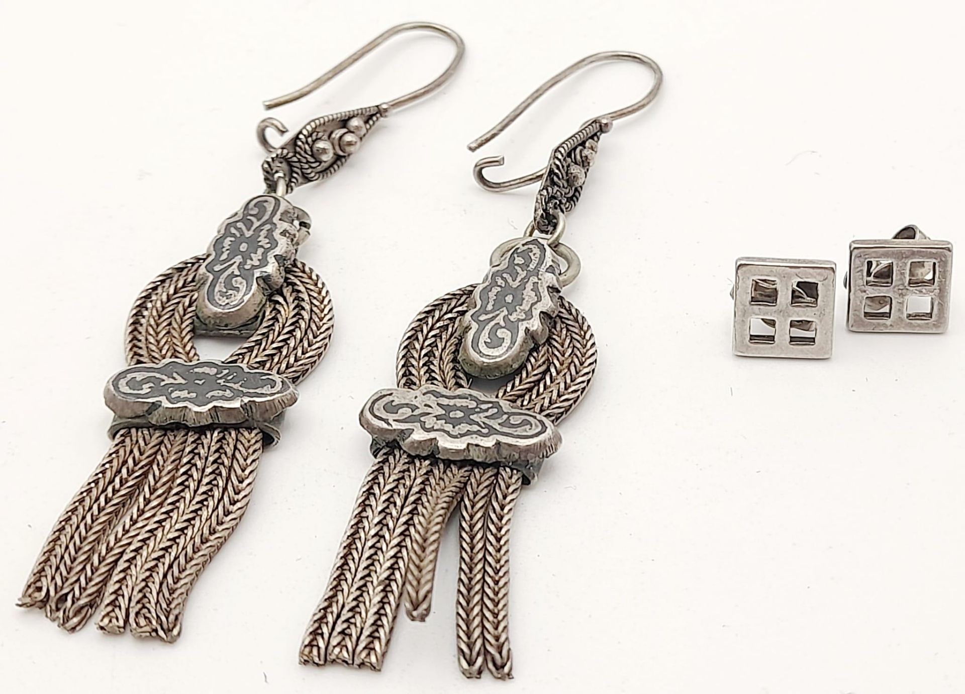 2X very stylish pairs of silver earrings. Total weight 12.6G. Please see photos for details.