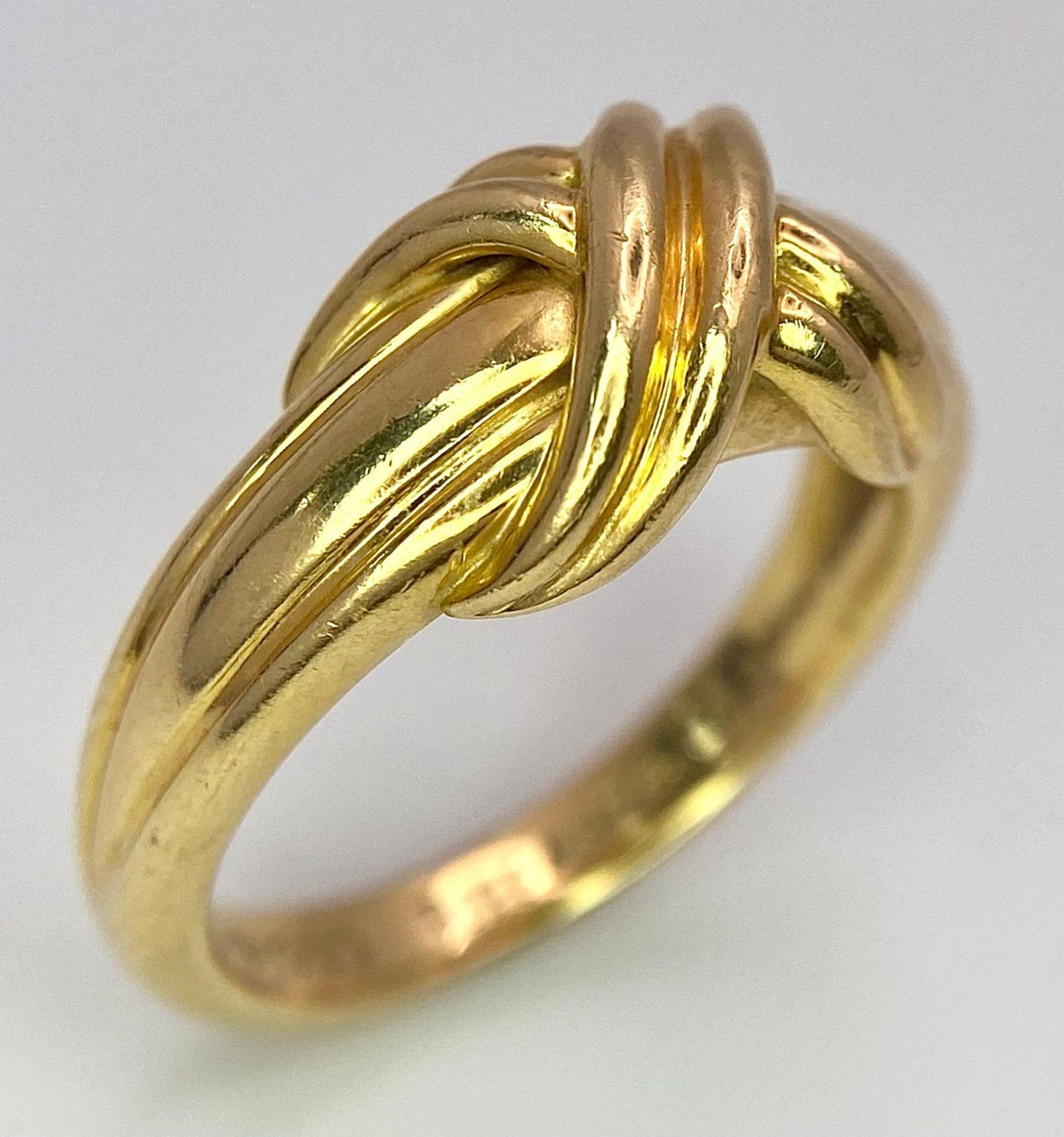 A Beautiful Tiffany and Co. 18K Gold Love Ring. Tiffany and co. markings. Size N. 7.2g weight.
