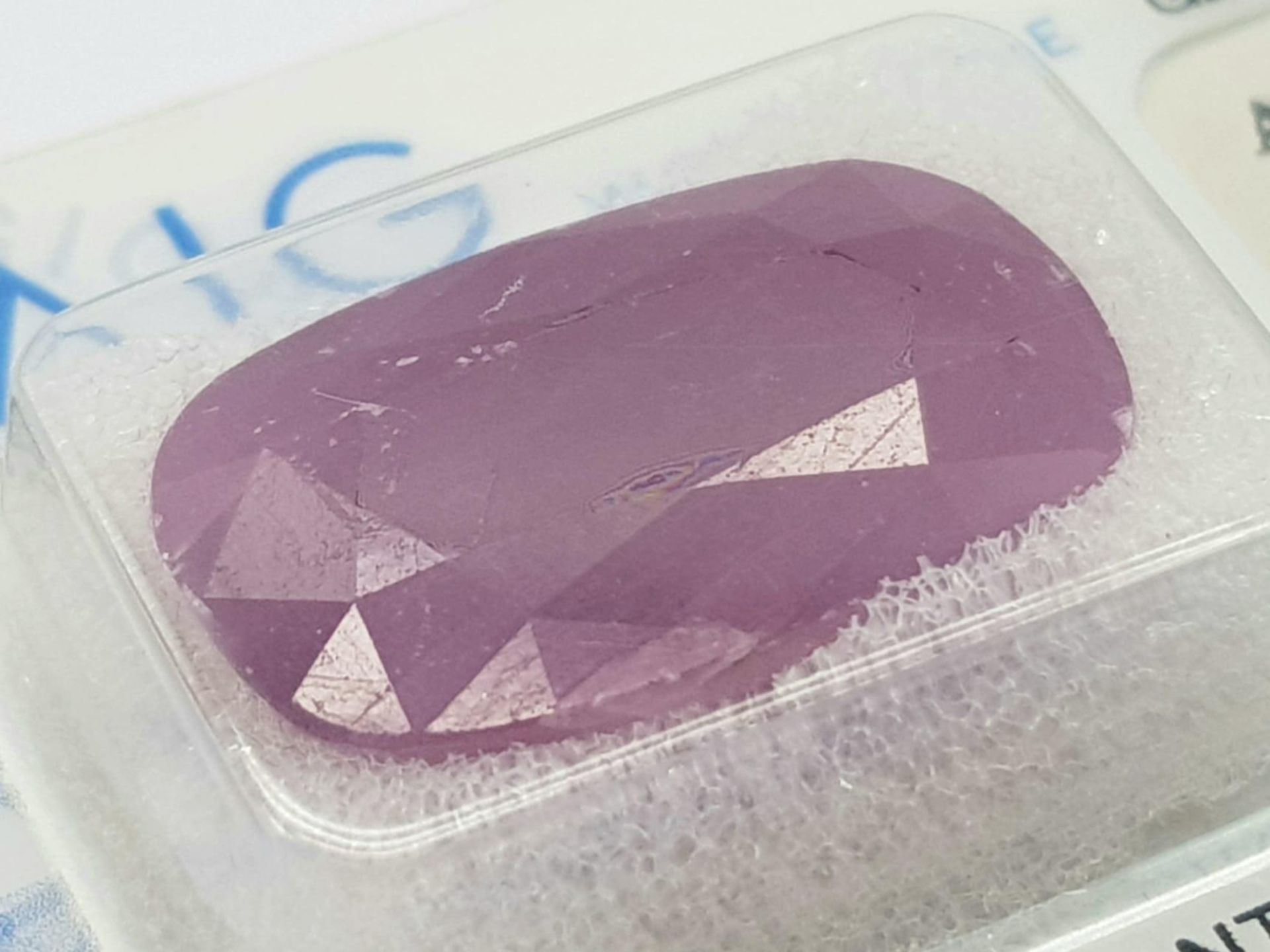 A Sealed 18.9ct Natural Rare Ruby, in the Cushion Faceted Shape. Comes with the AIG Milan - Image 4 of 9