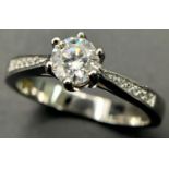 A 0.5ct White Moissanite Ring set in 925 Silver. Size N. Comes with a GRA certificate.