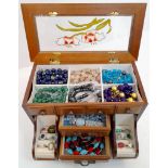 A mini jewellery box with a selection of precious and semiprecious stone sets including lapis