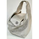 A Chanel Champagne and Silver Shimmer Bag. Leather exterior with single handle and open cover folds.