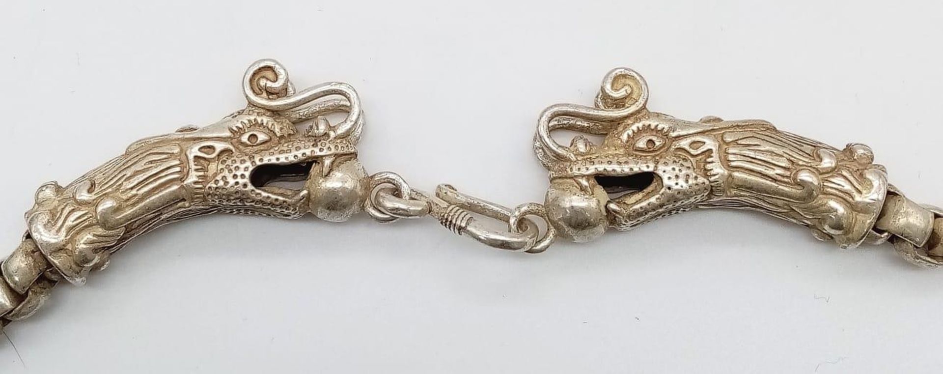 A vintage, Tibetan silver, chain necklace with two dragon heads with a ball in their mouth. - Image 3 of 5