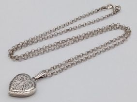 A vintage sterling silver heart locket pendant on silver belcher chain. Full Birmingham hallmarks,