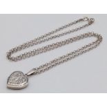 A vintage sterling silver heart locket pendant on silver belcher chain. Full Birmingham hallmarks,