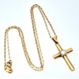 A 9 K yellow cross with a single round cut diamond on a 41 cm long 9 K gold chain. Cross dimensions: