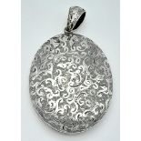 A large vintage sterling silver locket pendant with fabulous engravings. Total weight 22.2G. 6.5X3.5