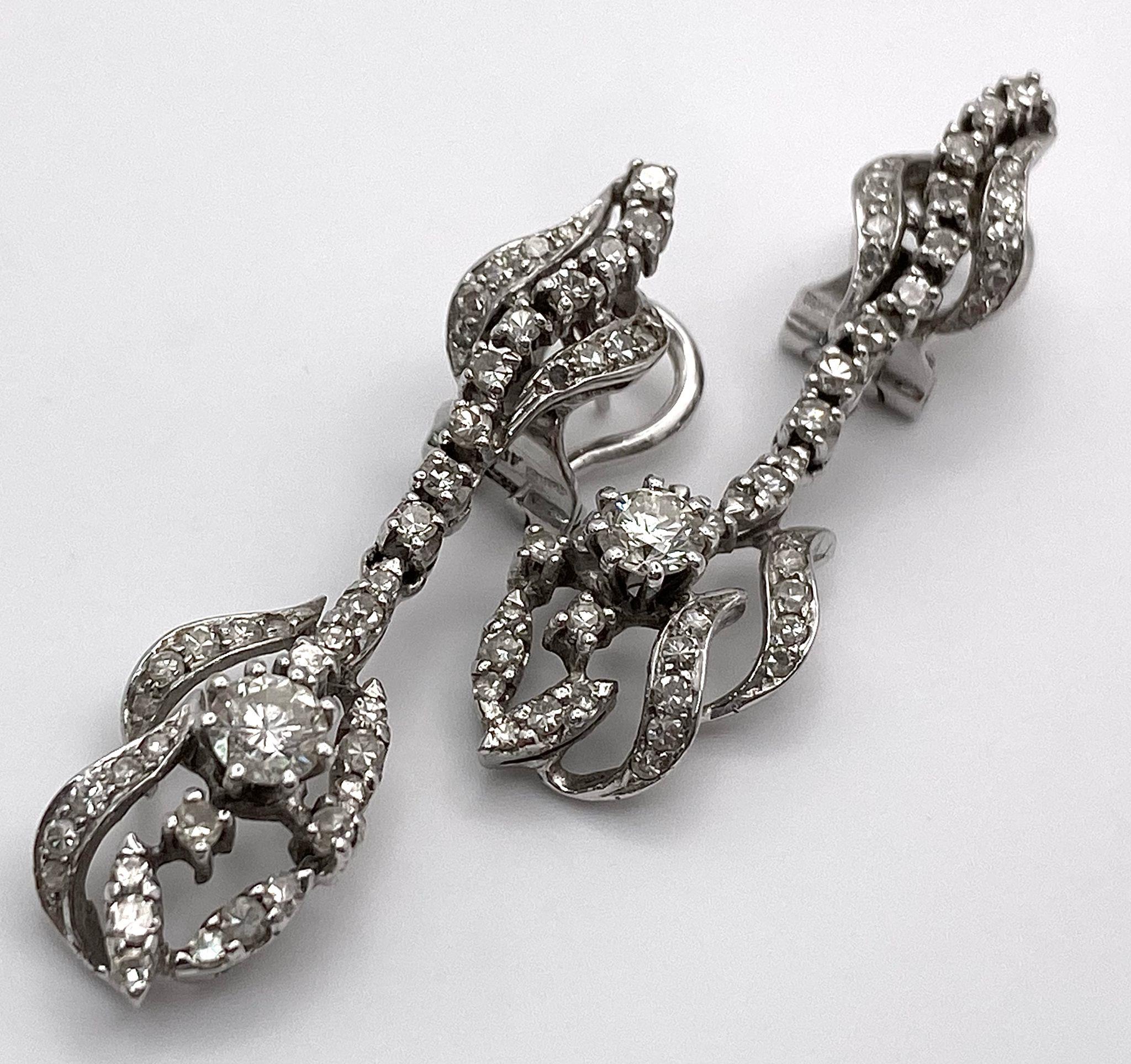 A Pair of Art Deco Style 18K White Gold and Diamond Drop Earrings. An array of round and brilliant - Image 5 of 15