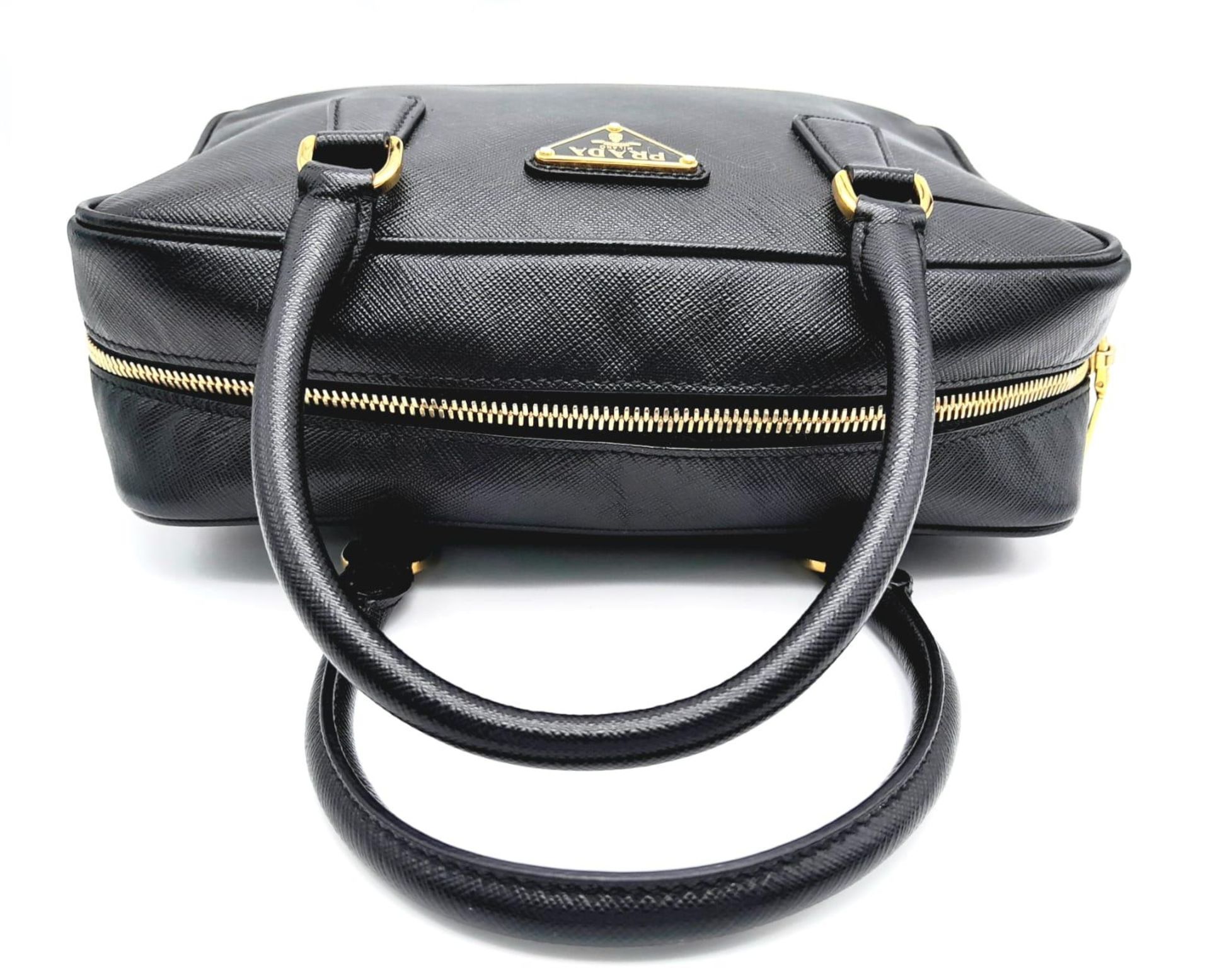 A Prada Black Bauletto Handbag. Saffiano leather exterior with gold-toned hardware, padlock, 2 - Image 6 of 11