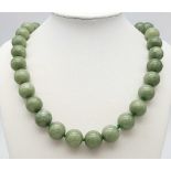 A Chinese 'Frozen Moss' Green Coloured Jade Necklace. 14mm beads. 46cm necklace length.