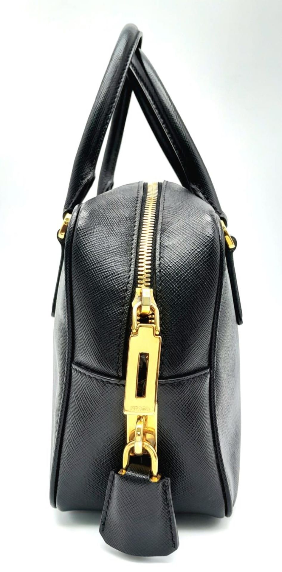A Prada Black Bauletto Handbag. Saffiano leather exterior with gold-toned hardware, padlock, 2 - Image 4 of 11