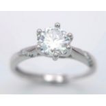 a sterling silver ring with a round cut moissanite (1 carat) and a band of moissanites on each