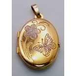 A 9K Yellow Gold Oval Locket Pendant. Decorative white gold floral scene. 3cm. 2.2g weight.