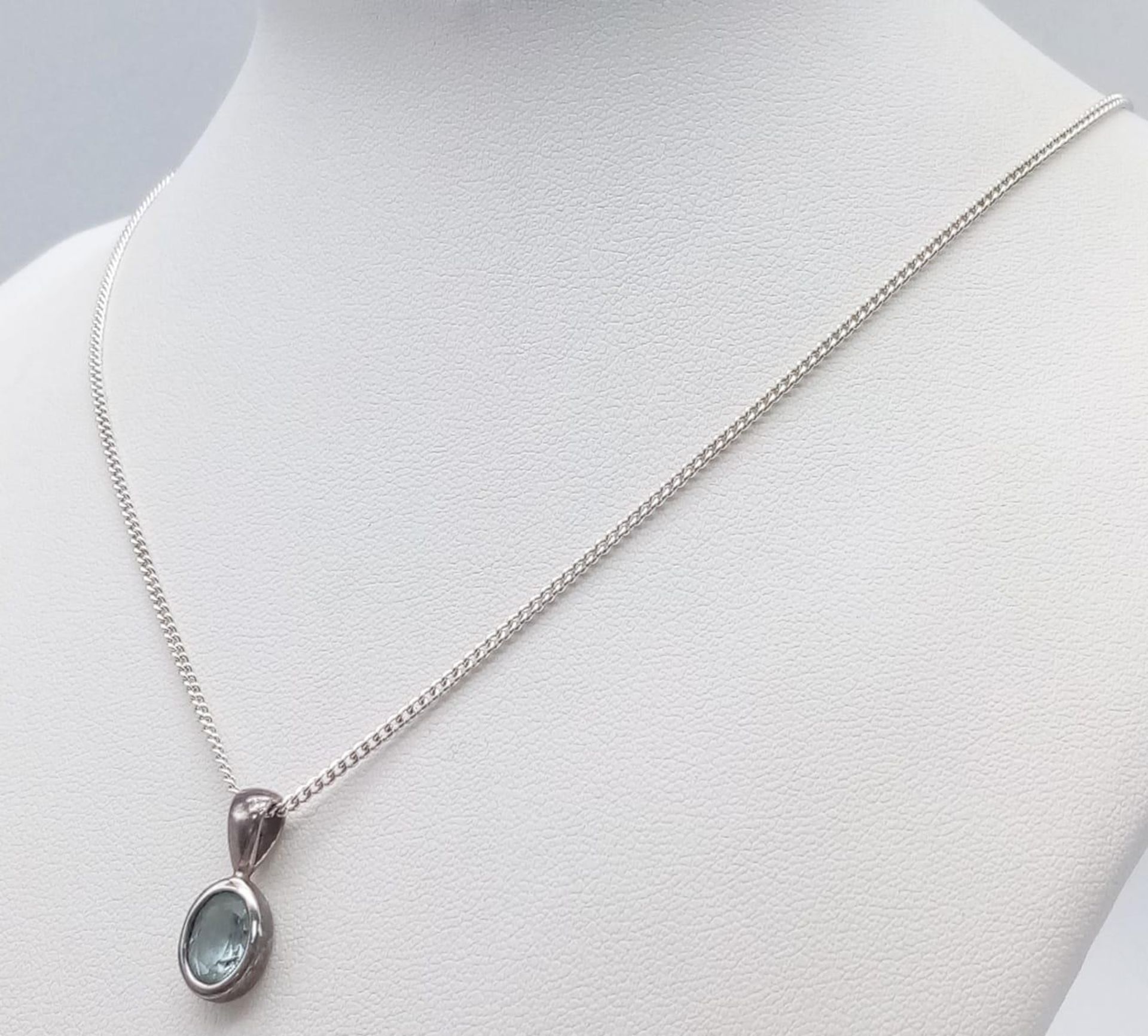 A Sterling Silver Blue Topaz Pendant on Chain. 1.8cm pendant, 46cm chain, 4.7g total weight. Ref: SC - Image 3 of 11