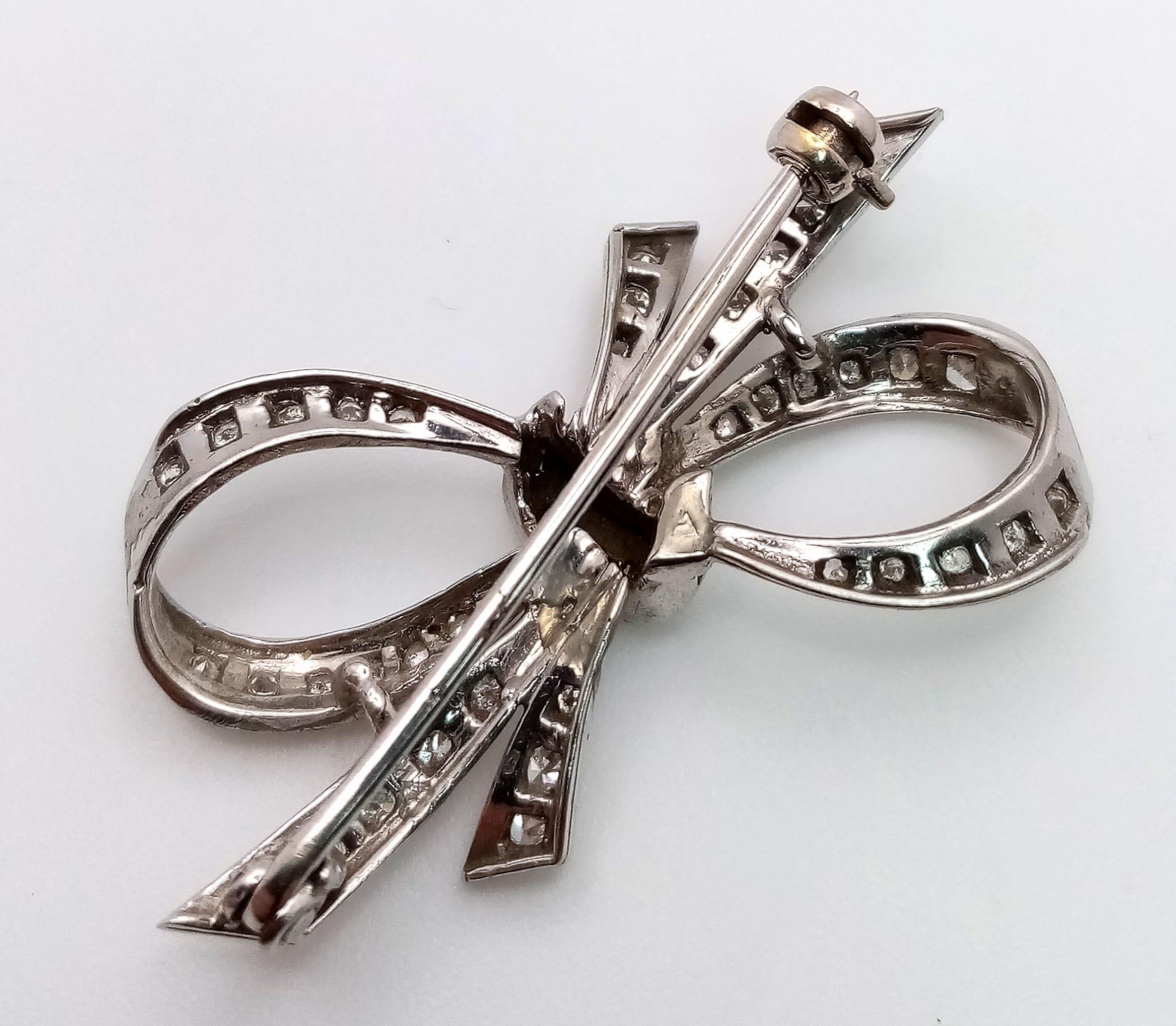 An Art Deco Style Platinum and Diamond Brooch. 1.2ctw of encrusted diamonds in a bow form. 4cm. 5.7g - Image 2 of 3