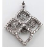 A 9 K white gold four sector pendant with diamonds and moving diamonds in each sector. Dimensions: