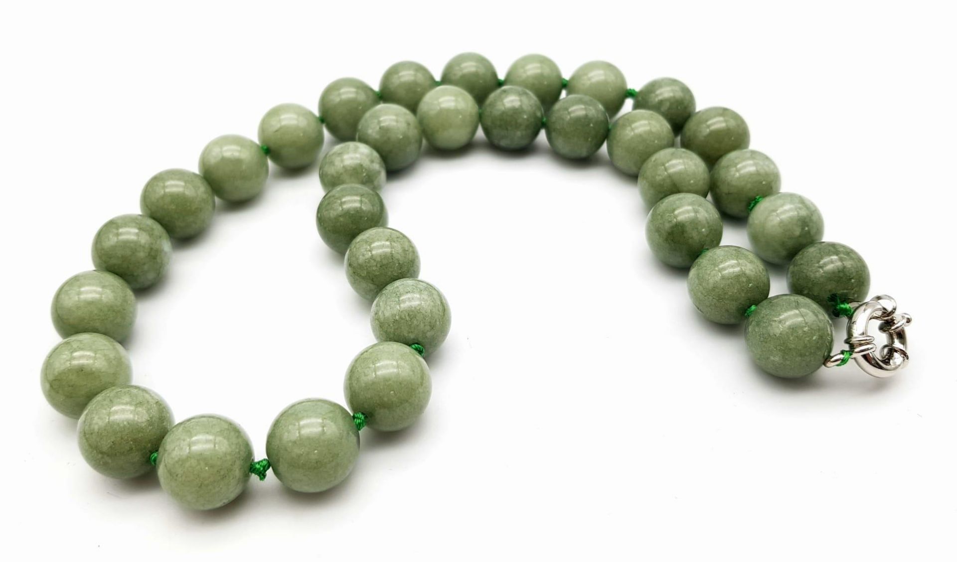 A Chinese 'Frozen Moss' Green Coloured Jade Necklace. 14mm beads. 46cm necklace length. - Image 3 of 3