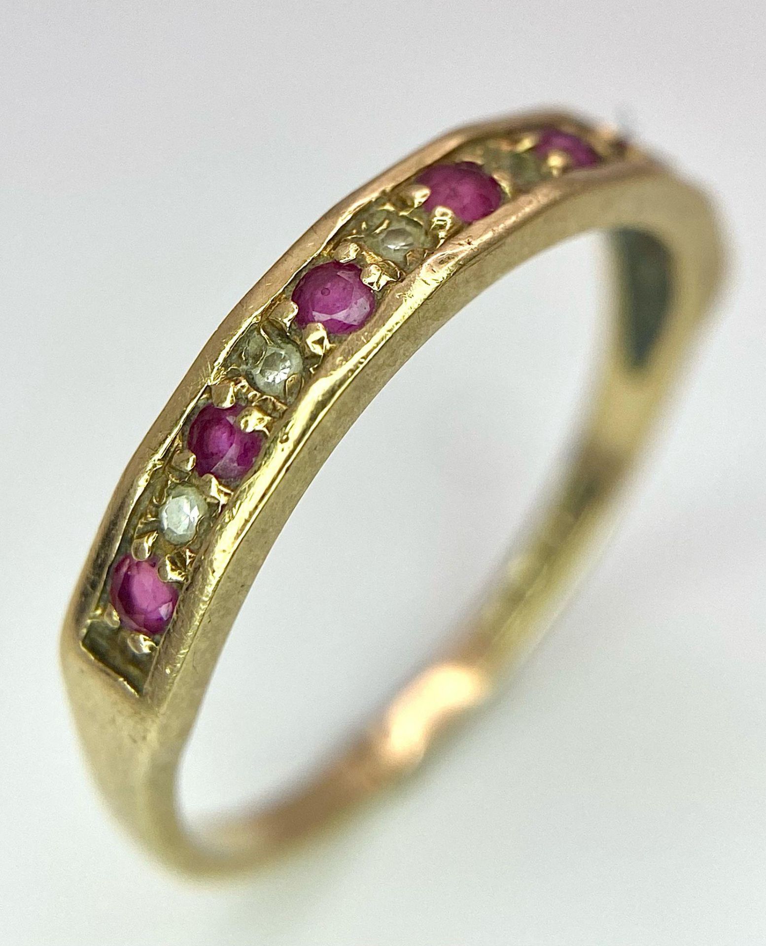 A 9K GOLD RUBY AND DIAMOND RING . 1.6gms size N