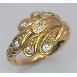 An 18 K yellow gold ring with an unusual design and eight good quality round cut diamonds. Size: