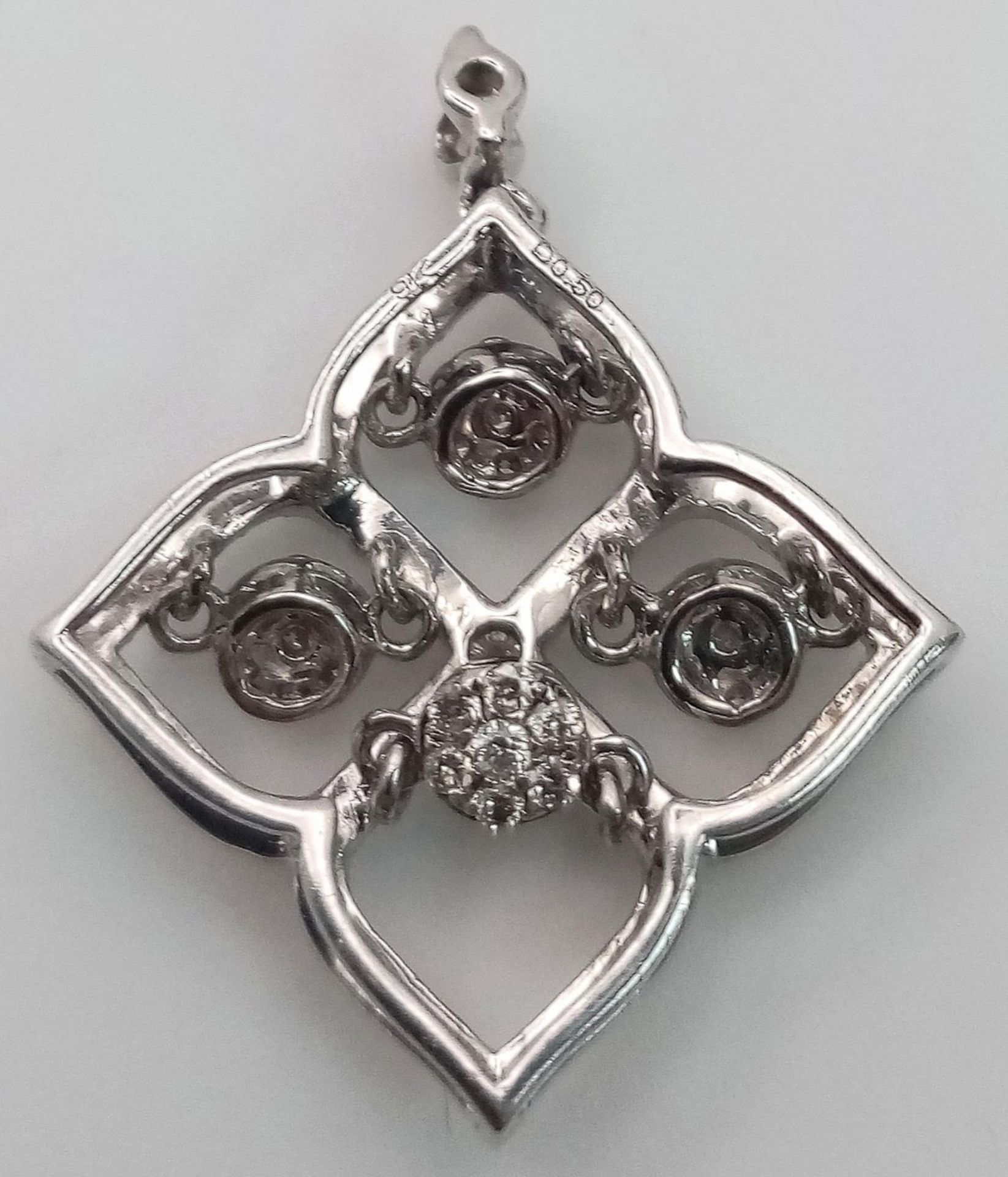 A 9 K white gold four sector pendant with diamonds and moving diamonds in each sector. Dimensions: - Image 2 of 6