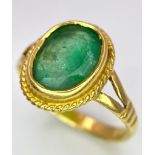 A 21K (tested) Green Emerald Ring. Central oval cut emerald. Size H. 3.15g weight.