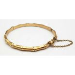 A 9K GOLD HINGED BANGLE IN BAMBOO STYLE . 9.0gms