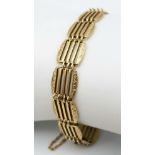 A 9K GOLD ORNATELY DECORATED GATE BRACELET . 11.1gms