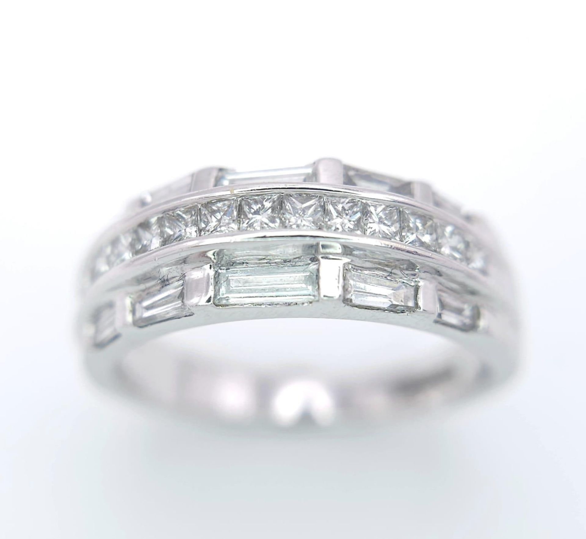 AN 18K WHITE GOLD DIAMOND SET BAND RING - 3 ROWS OF 1CTW OF DIAMOND MIXTURE OF PRINCESS AND BAGUETTE