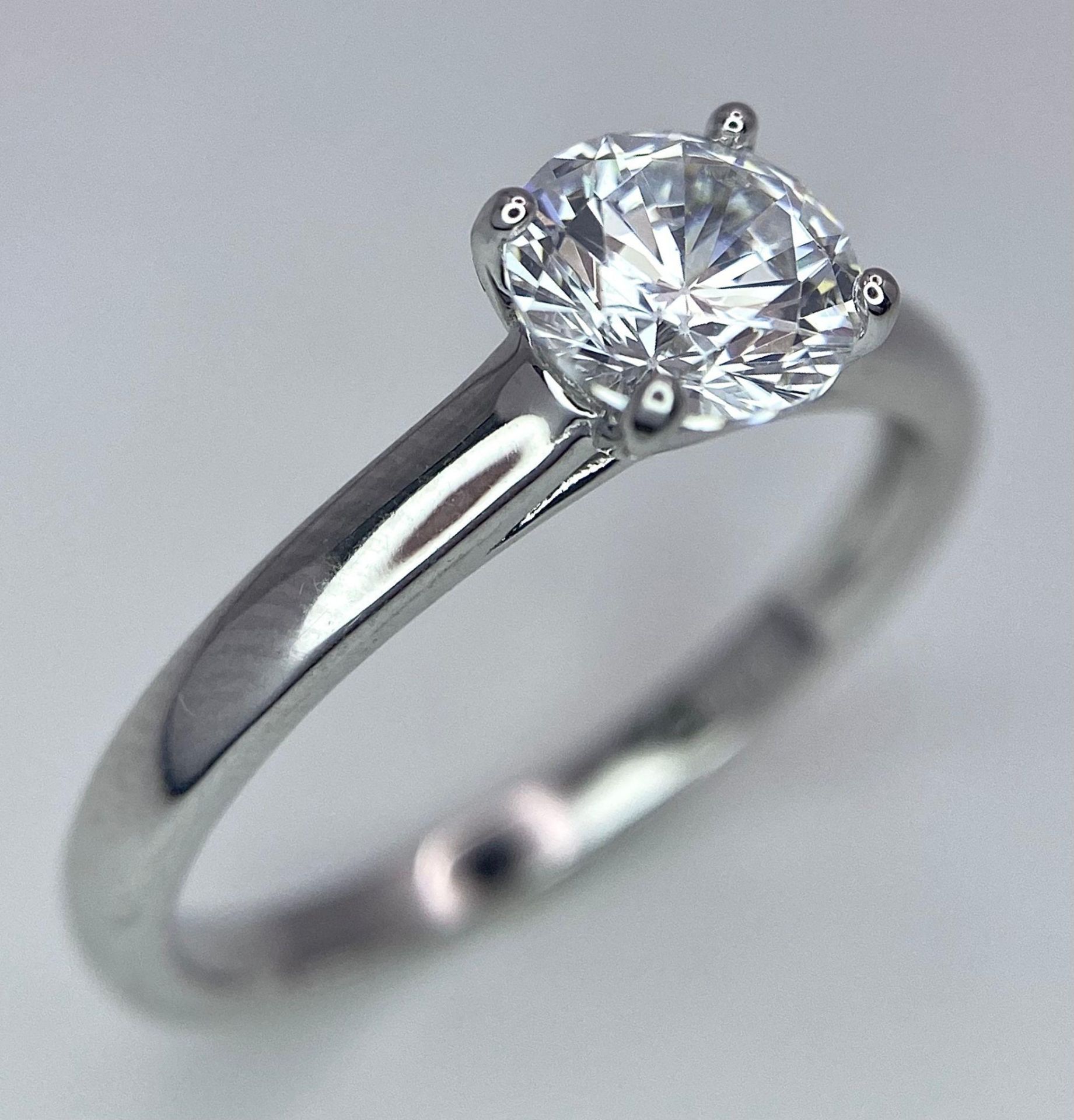 A sterling silver solitaire ring with a round cut cubic zirconium. Size: N, weight: 2 g.