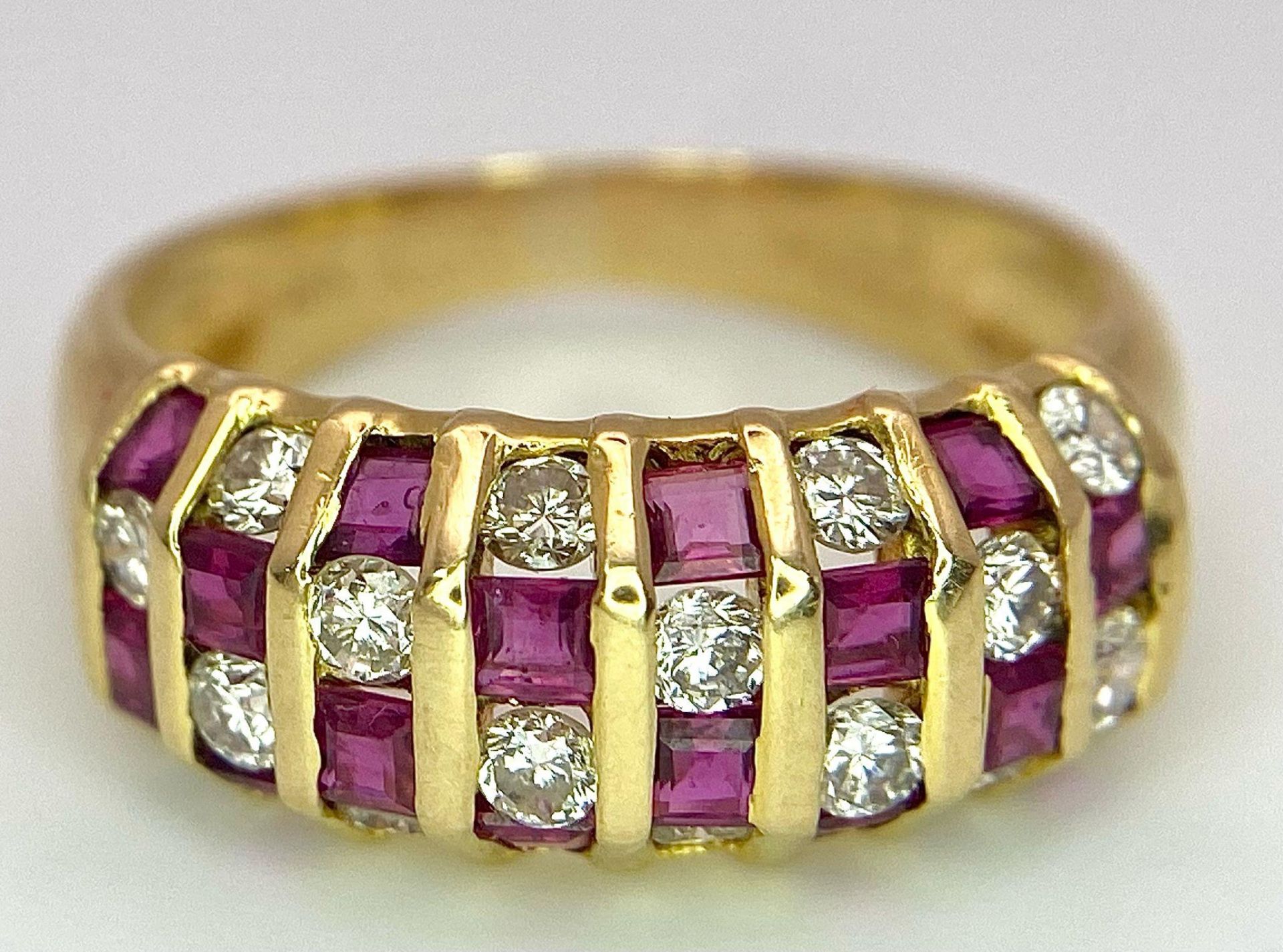 A STUNNING 18K GOLD DIAMOND AND RUBY RING , HAVING 4 ROWS OF ALTERNATING STONES . 4.1gms size M - Image 6 of 15