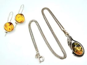 A matching set of 925 silver Amber jewellery include a pair of earrings and a pendant on silver