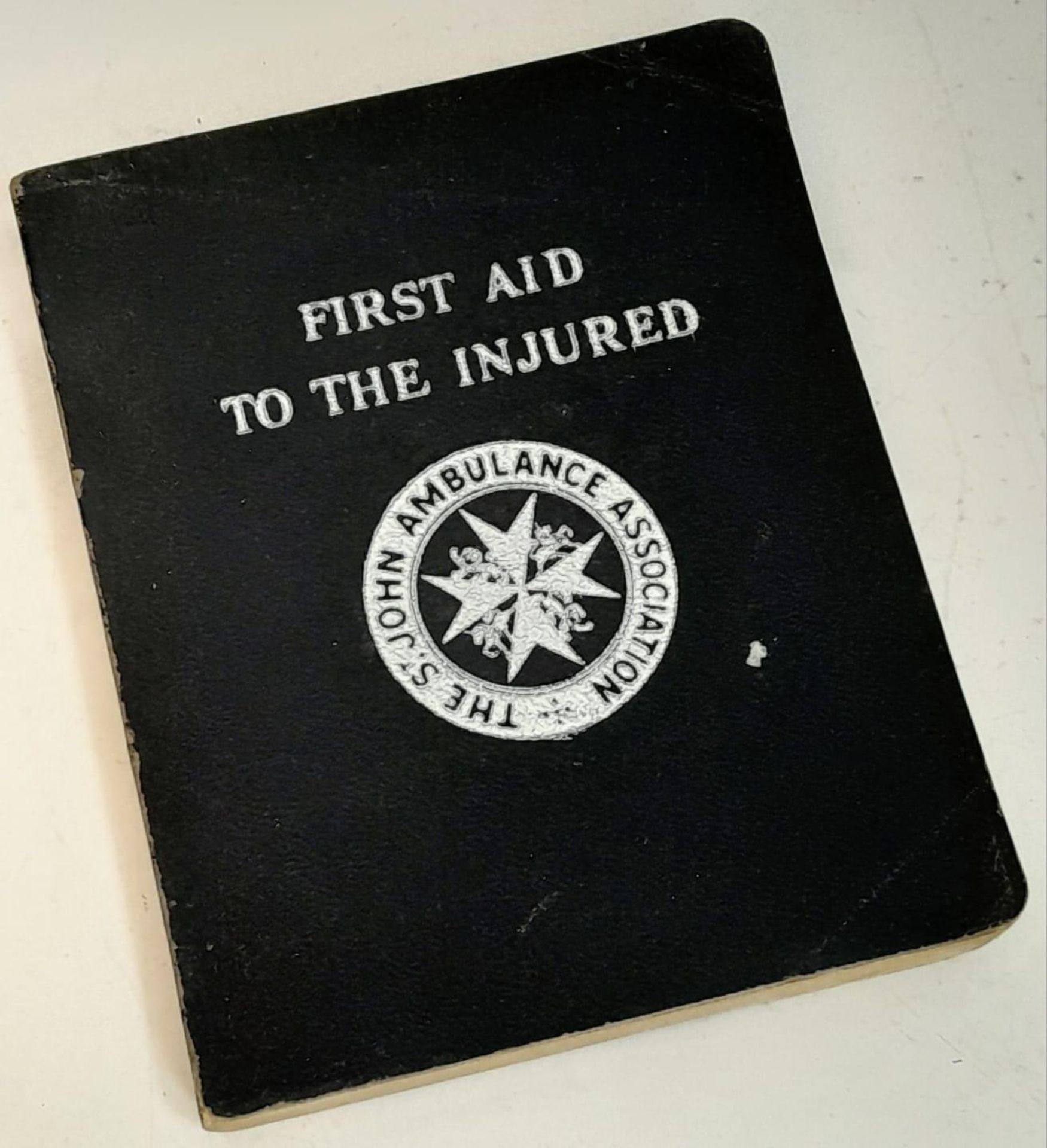 A FIRST AID TO THE INJURED book produced by the St John Ambulance Association, 1943 Edition.