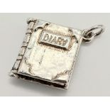 A STERLING SILVER DIARY CHARM/PENDANT, WHICH OPENS UP, WEIGHT 4.8G