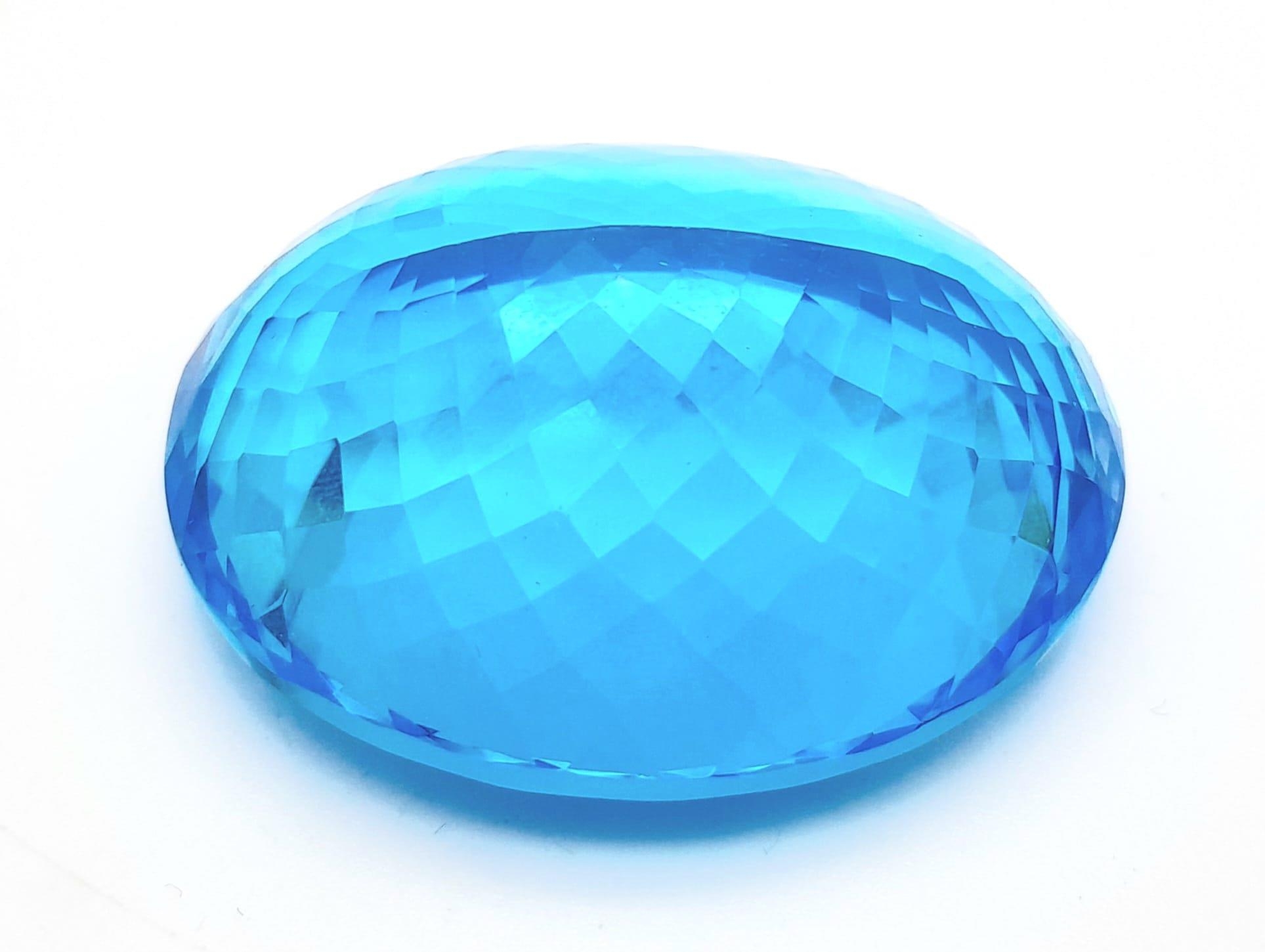 A large (162.81 carats), oval cut natural topaz, with vivid sky blue uniform colouration, - Image 2 of 4