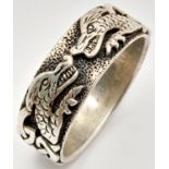 A vintage 925 silver band ring with magnificent dragon motif engravings. Total weight 9.7G. Size Z