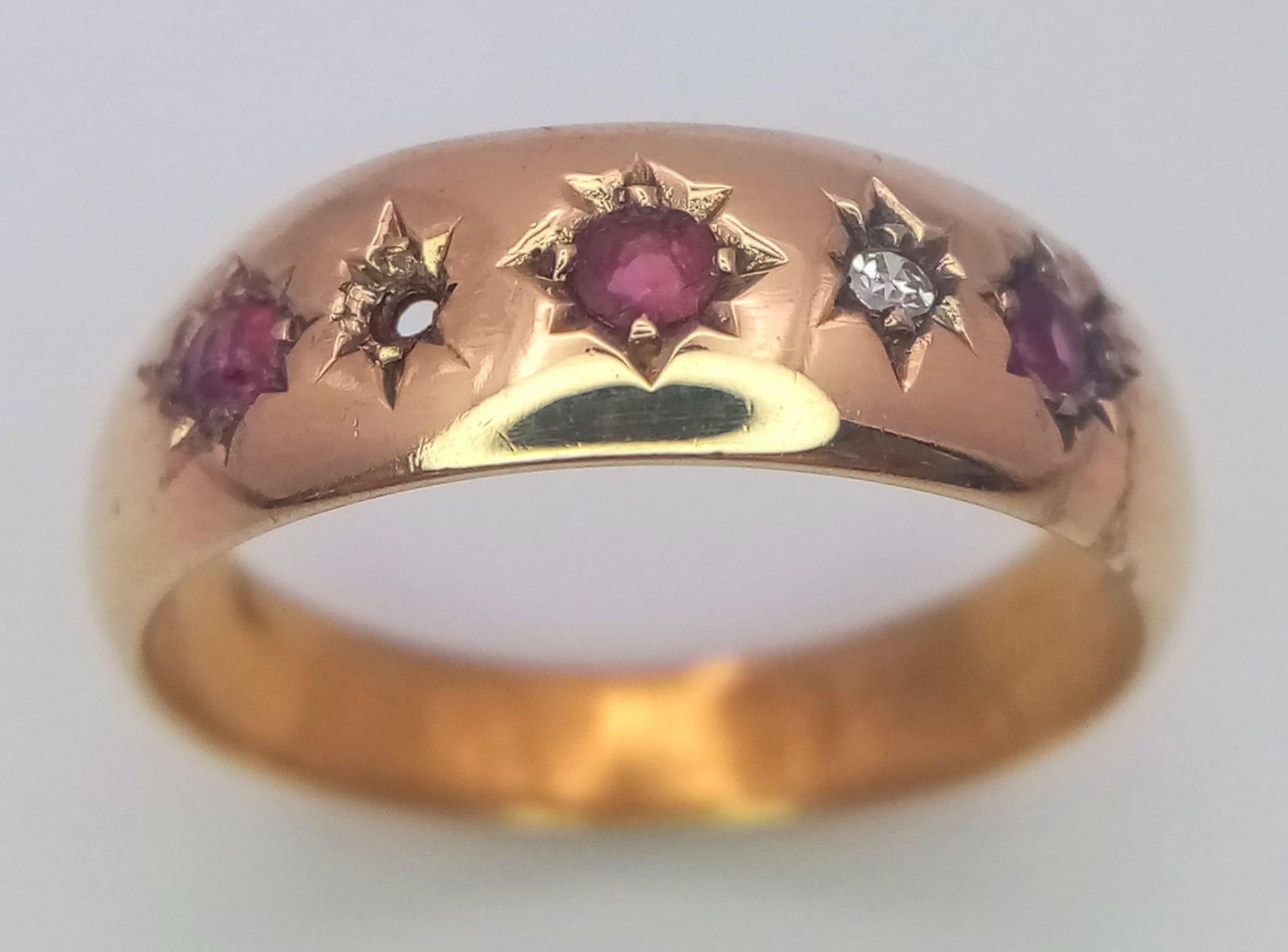 A VINTAGE 18K YELLOW GOLD DIAMOND & RUBY 5 STONE RING (one stone missing). 2.3G. SIZE N.