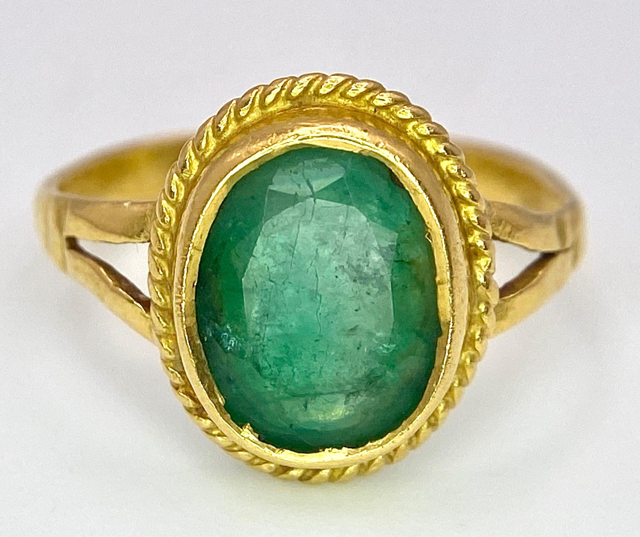 A 21K (tested) Green Emerald Ring. Central oval cut emerald. Size H. 3.15g weight. - Image 4 of 5