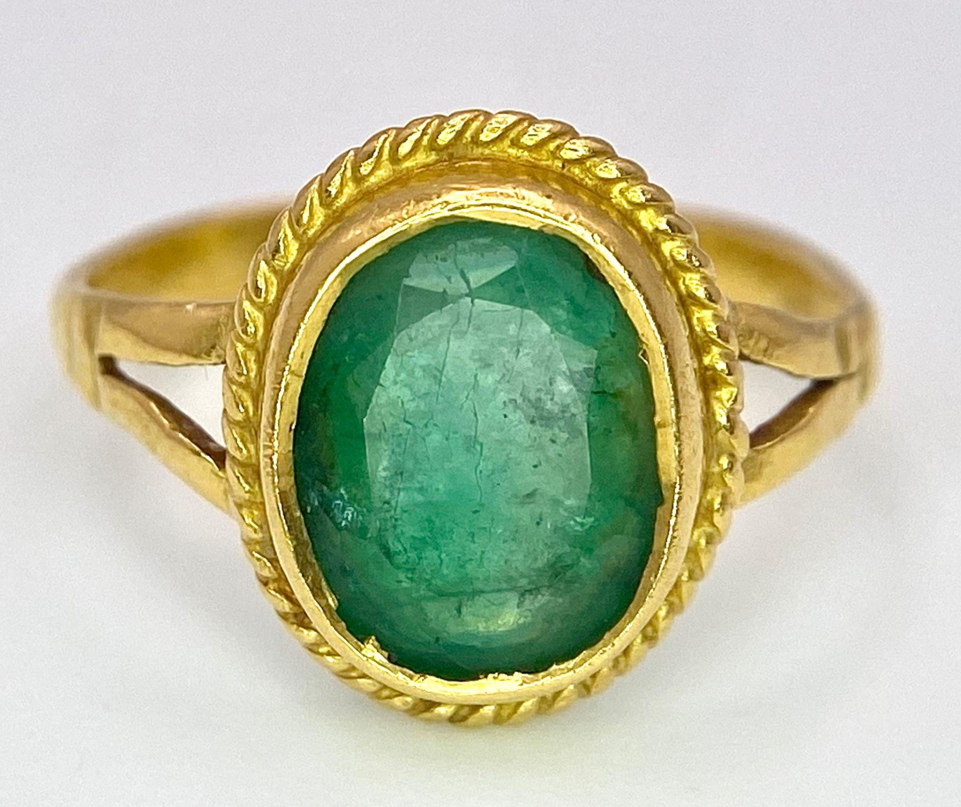 A 21K (tested) Green Emerald Ring. Central oval cut emerald. Size H. 3.15g weight. - Image 4 of 5