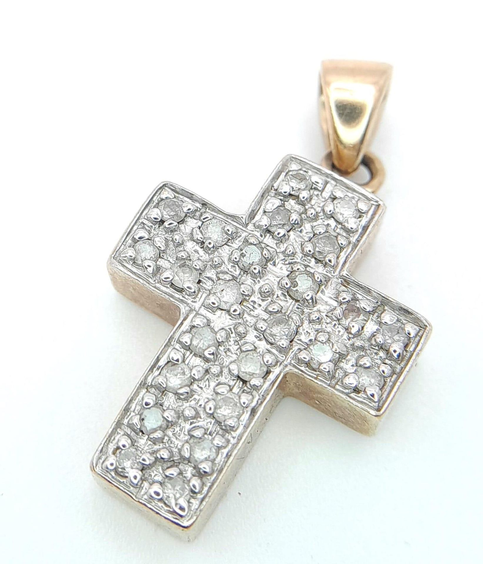 A 9 K yellow gold cross studded with diamonds (0.25 carats), dimensions (with bail): 24 x 14 x 4 mm,