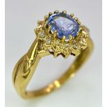 An 18K Yellow Gold Diamond and Sapphire Ring. Central oval sapphire with a diamond surround. Size O.