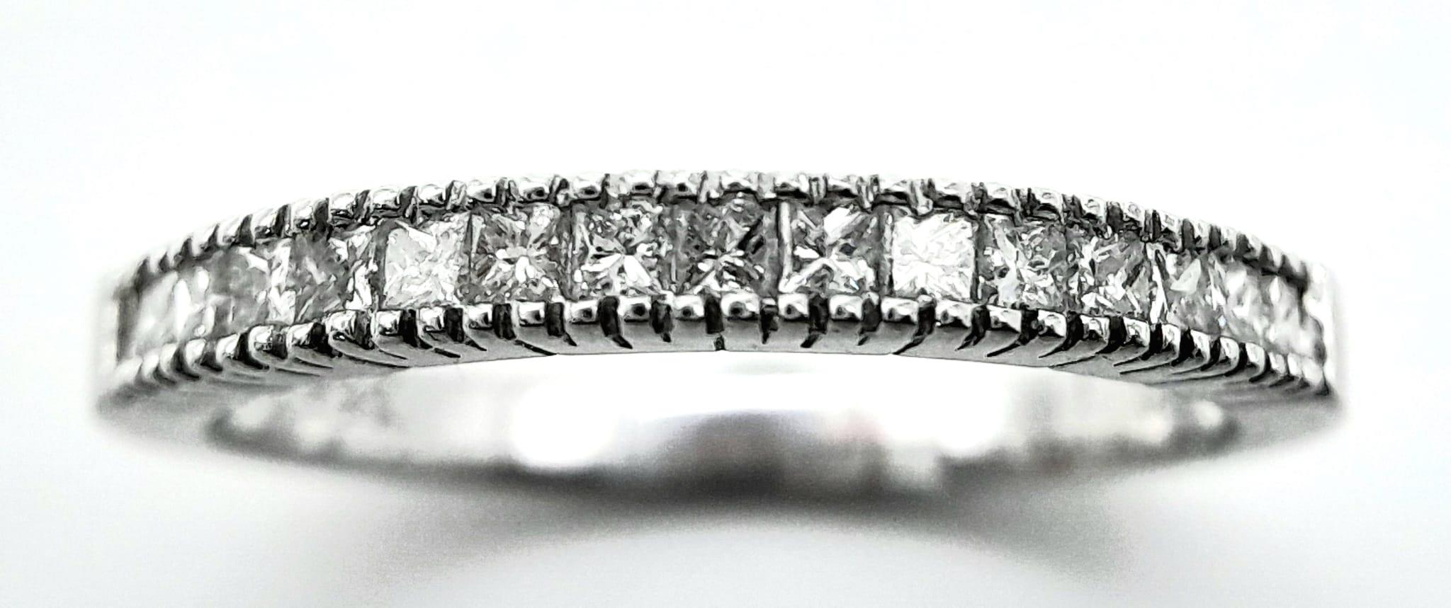 AN 18K WHITE GOLD DIAMOND SET BAND RING - PRINCESS CUTS. 0.50CTW. 2.8G. SIZE P 1/2.